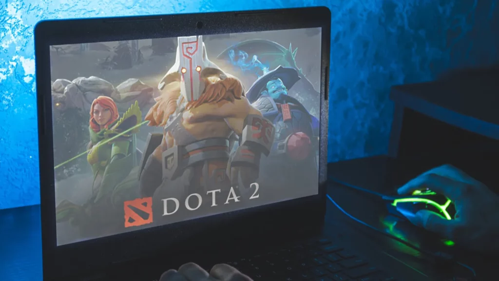 Man playing Dota 2 on laptop