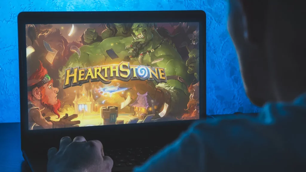 Man playing Hearthstone on his laptop