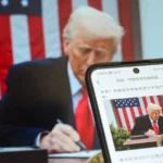US president Donald Trump signing a document.