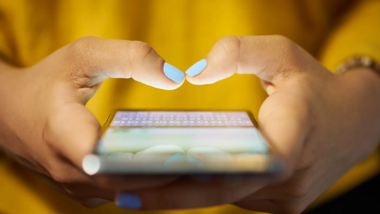 woman typing phone message on social network at night