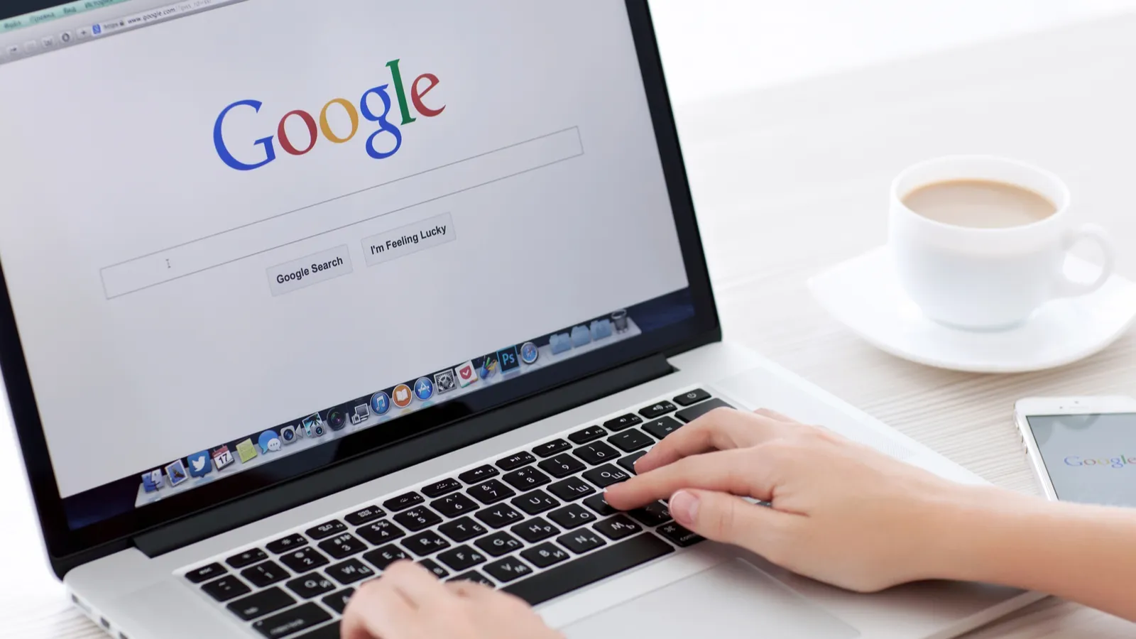 Man searching on google search on Macbook
