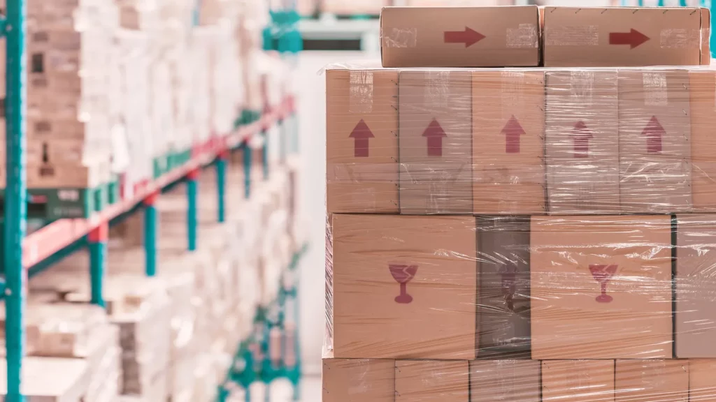 corrugated paperboard carton stacked on shelf in warehouse or depot